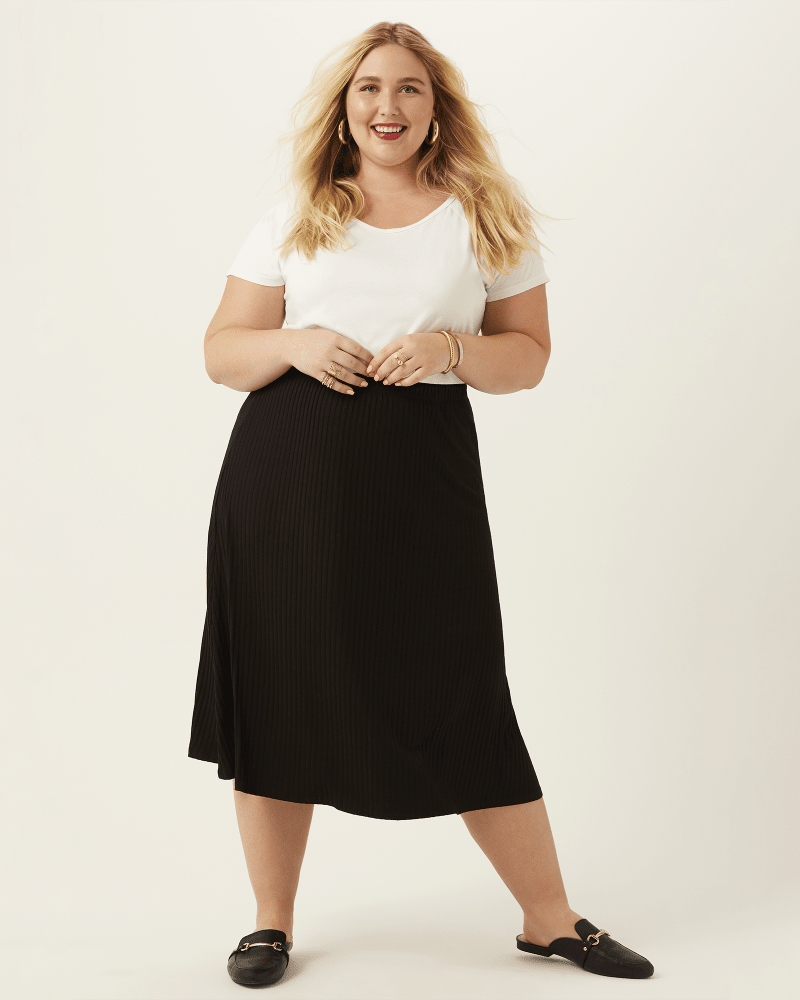 Plus size model with pear body shape wearing Karla Ribbed Knit Midi Skirt by CCM | Dia&Co | dia_product_style_image_id:170291